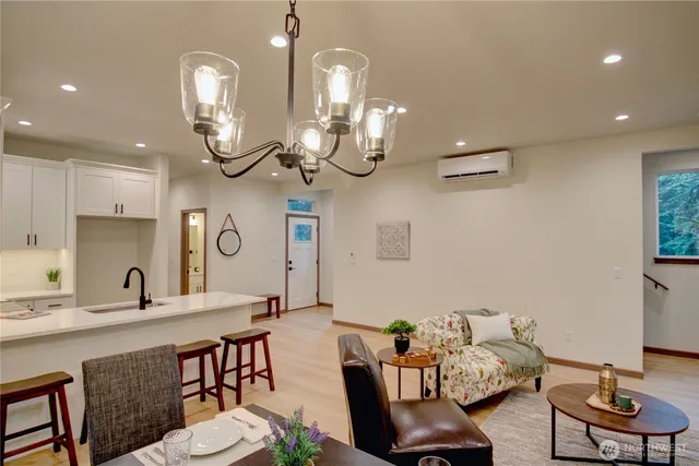 a view of a dining room with furniture a chandelier and wooden floor