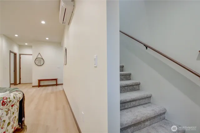 a bedroom with a large bed and a potted plant