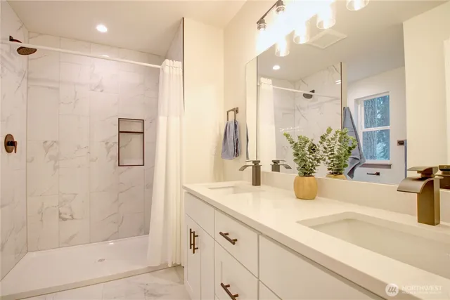 a bathroom with a double vanity sink and a mirror