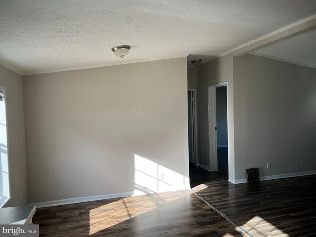 a view of an empty room and wooden floor
