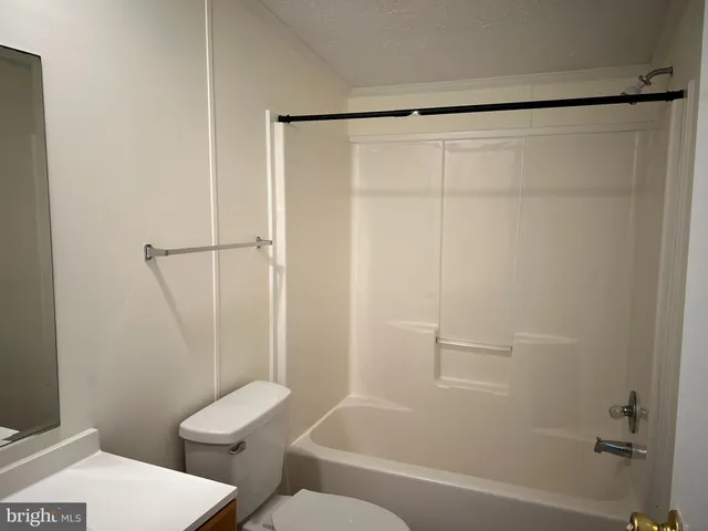 a bathroom with a shower and a toilet