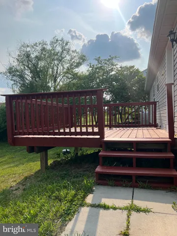 a view of a bench in back yard of a house