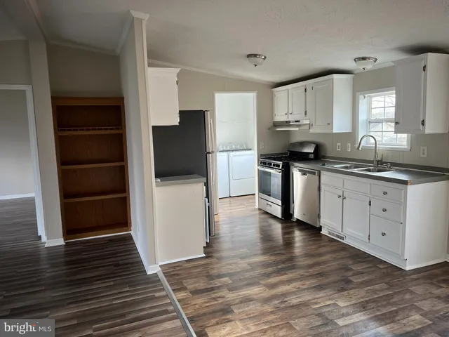 a kitchen with stainless steel appliances a stove and a refrigerator