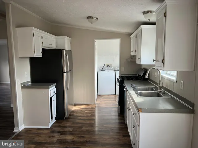 a kitchen with a refrigerator sink and stove