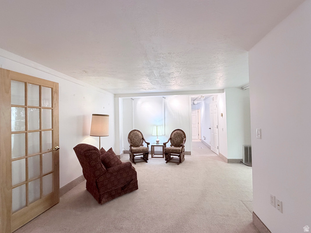 2855 South 1000 West Perry, UT 84302 - Photo 122 of 142 Sitting room with light carpet and a textured ceiling