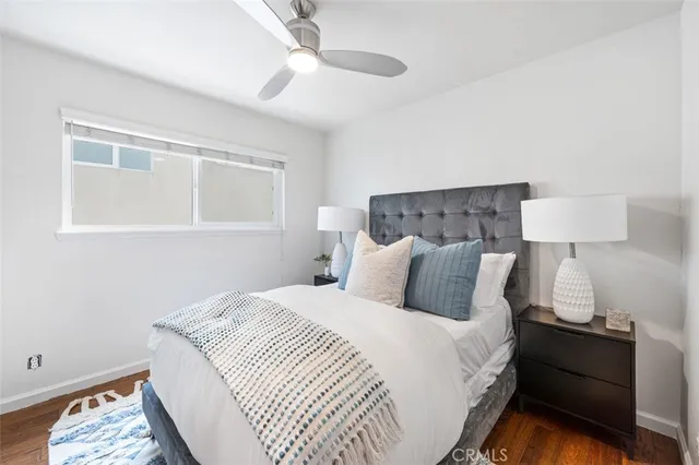 a bedroom with a bed and a large mirror