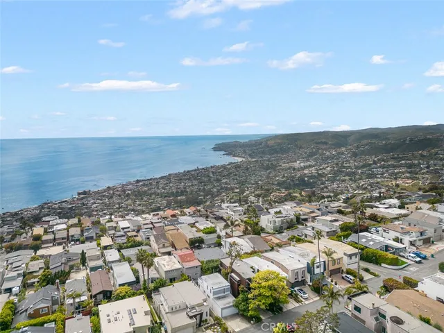 an aerial view of beach and residential building