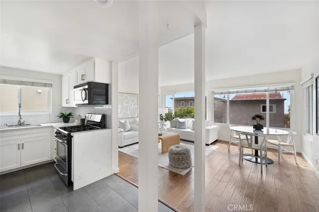 a kitchen with stainless steel appliances a refrigerator stove and microwave