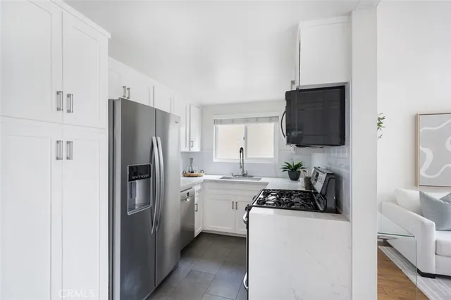 a kitchen with stainless steel appliances a stove a microwave and sink