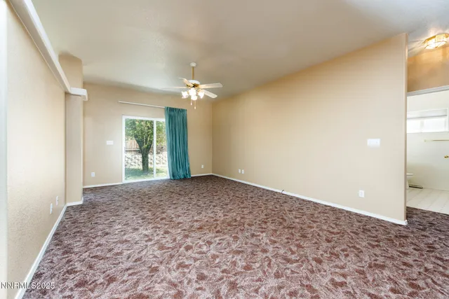 an empty room with windows and chandelier