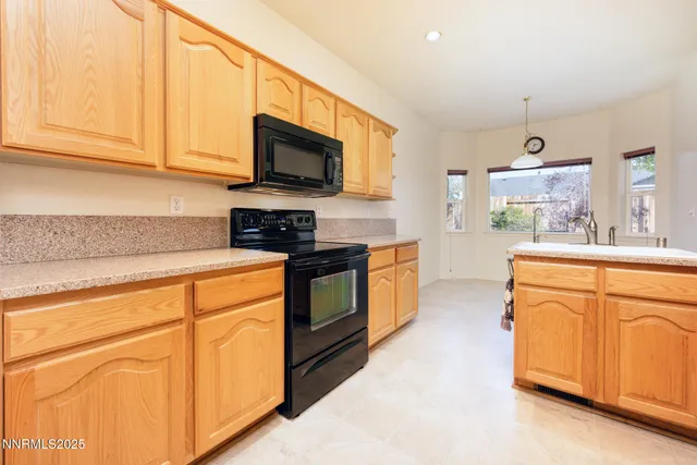 a kitchen with stainless steel appliances granite countertop a sink and a microwave