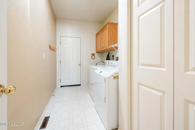 a view of a storage & utility room with a washer dryer