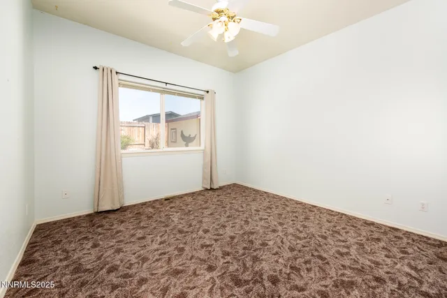 a view of a bedroom with wooden floor and a chandelier fan