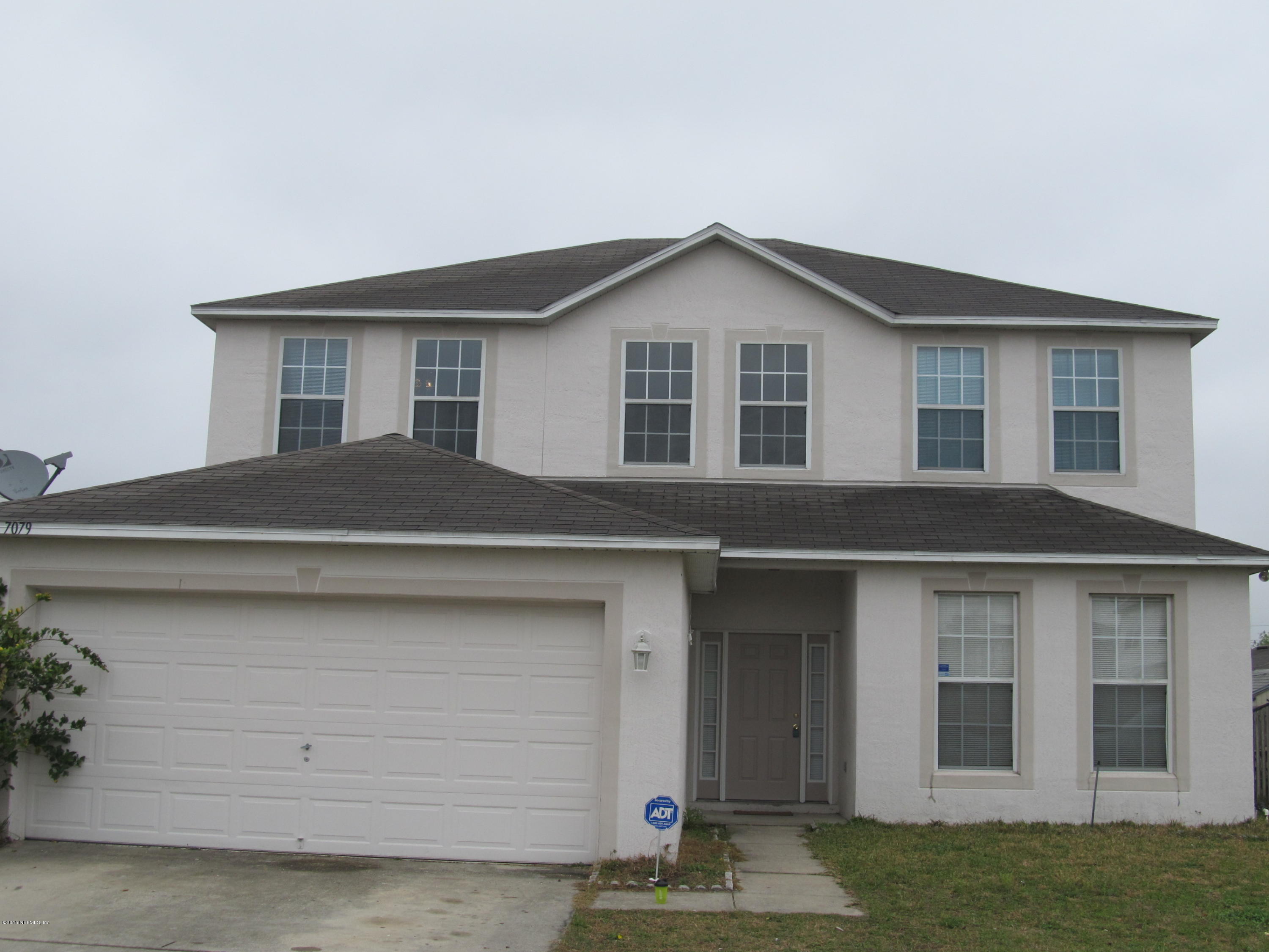 7079 Prosperity Park Road East Jacksonville, FL 32244 - Photo 1 of 22 a front view of a house with garage
