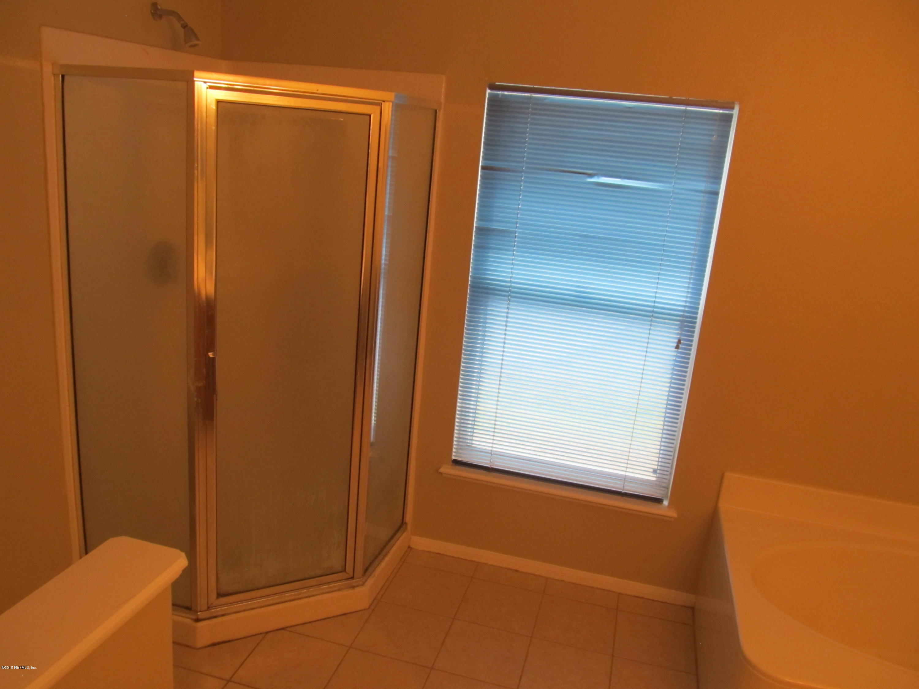 7079 Prosperity Park Road East Jacksonville, FL 32244 - Photo 14 of 22 a bathroom with a door