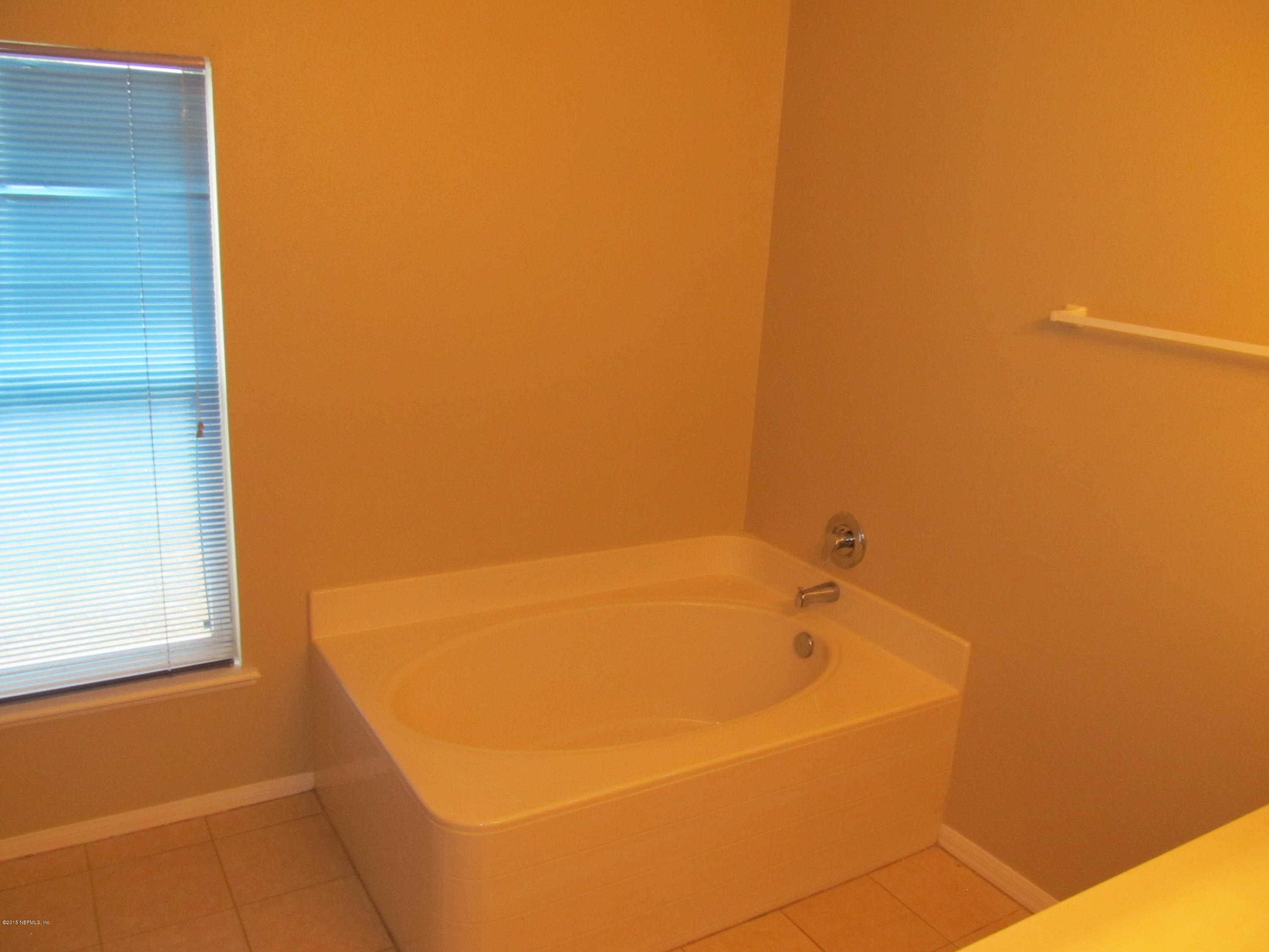 7079 Prosperity Park Road East Jacksonville, FL 32244 - Photo 15 of 22 a bathroom with a bathtub