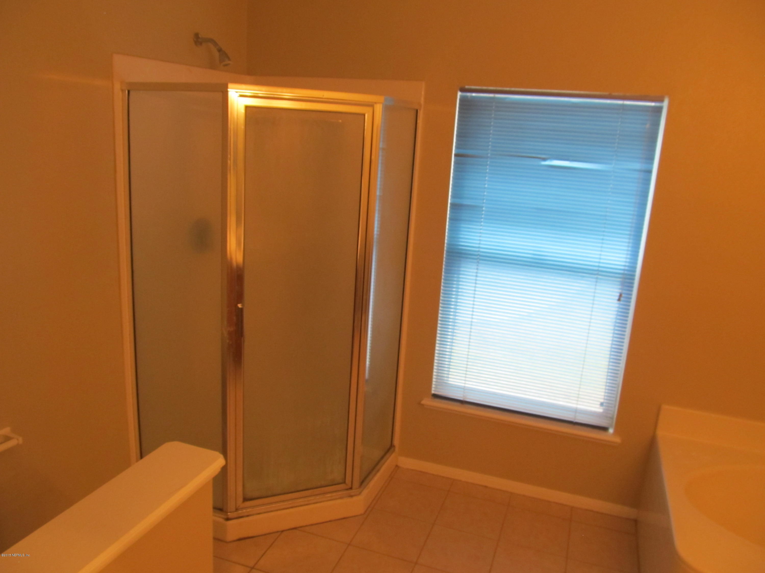 7079 Prosperity Park Road East Jacksonville, FL 32244 - Photo 16 of 22 a bathroom with a bathtub