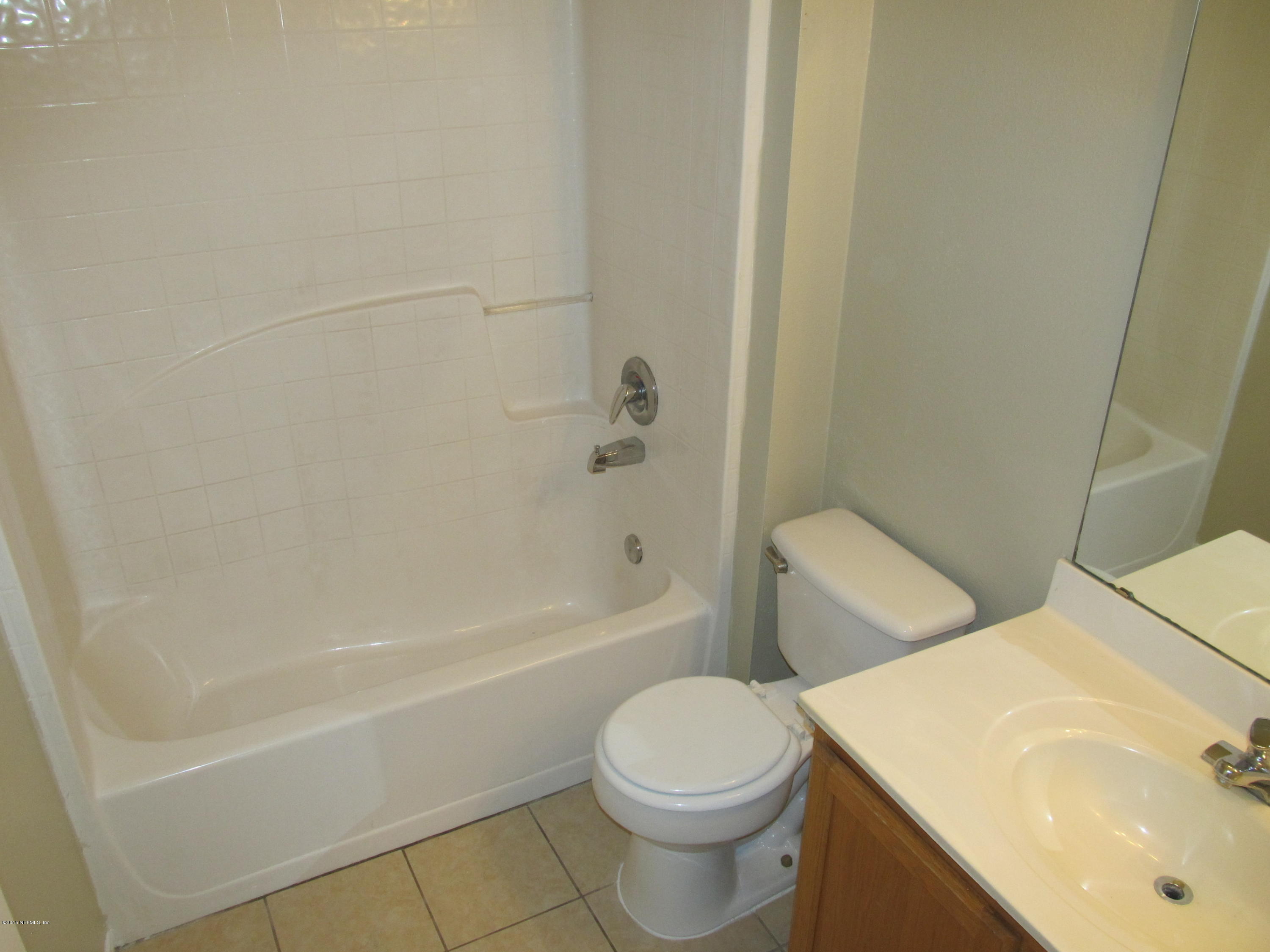 7079 Prosperity Park Road East Jacksonville, FL 32244 - Photo 17 of 22 a bathroom with a sink a toilet and bathtub