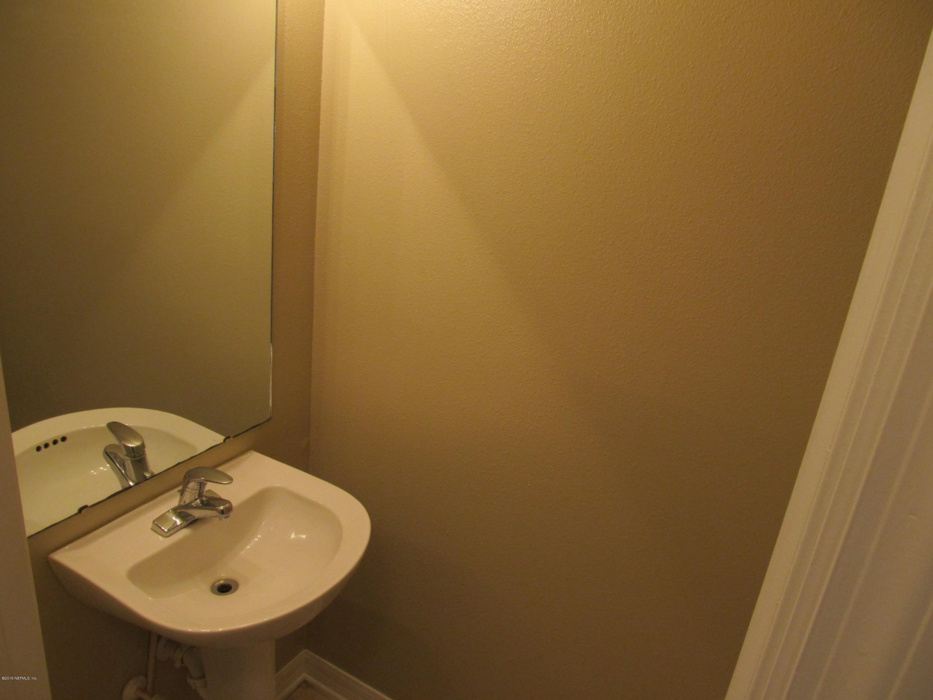 7079 Prosperity Park Road East Jacksonville, FL 32244 - Photo 21 of 22 a bathroom with a sink and mirror