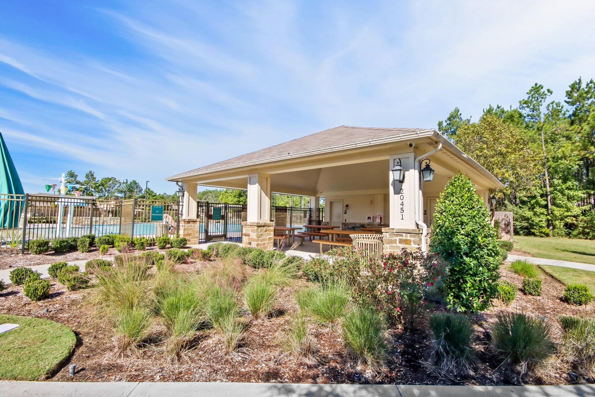 19956 Hilbert Road New Caney, TX 77357 - Photo 24 of 27 a view of a house with backyard sitting area and garden
