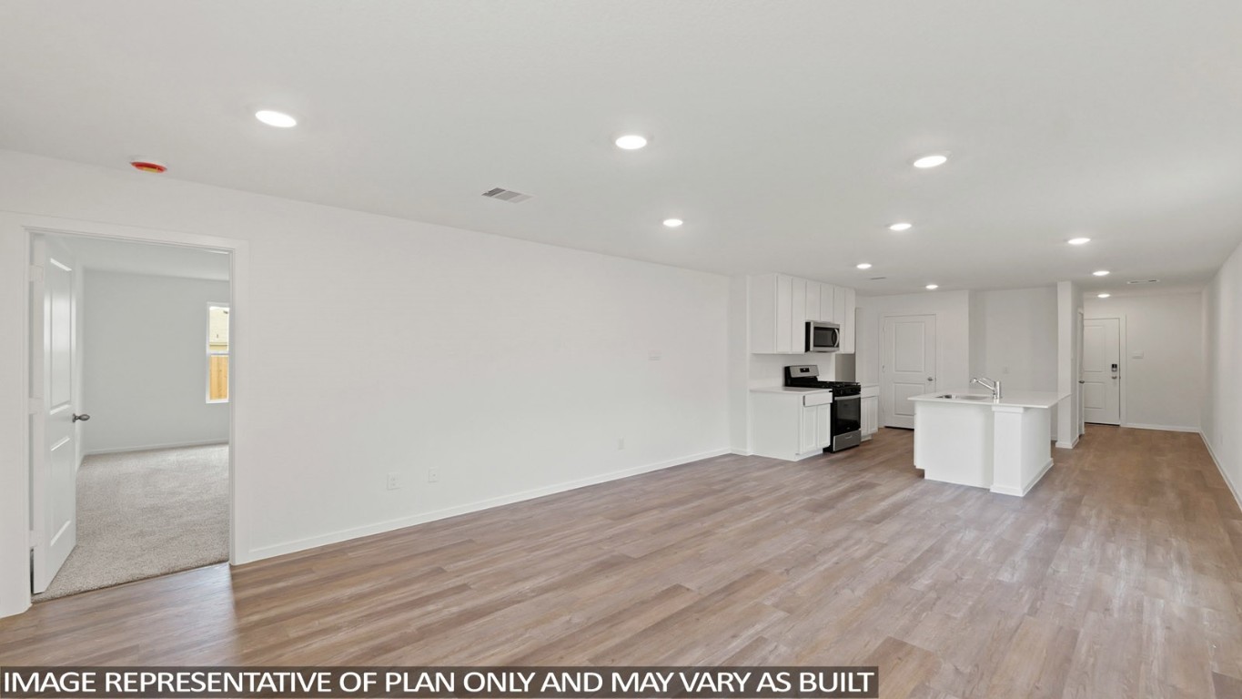 19956 Hilbert Road New Caney, TX 77357 - Photo 5 of 27 a view of a kitchen with a microwave and wooden floor