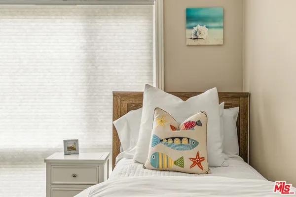a bedroom with a bed and cupboard