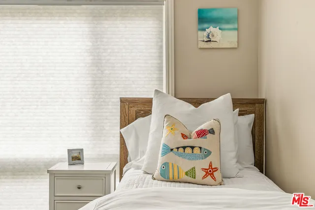 a bedroom with a bed and cupboard