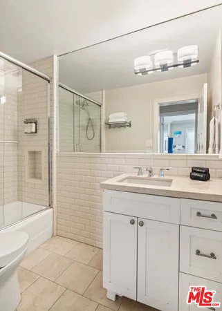 a bathroom with a sink a mirror and a shower
