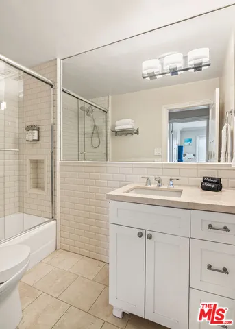 a bathroom with a sink a mirror and a shower