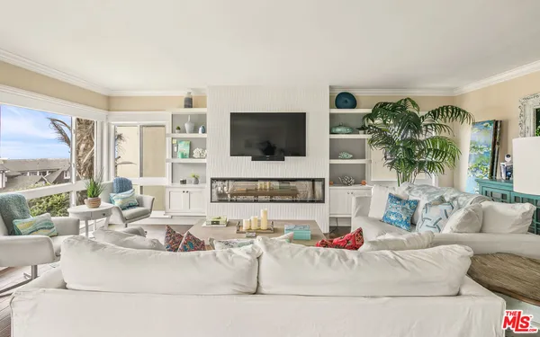 a living room with fireplace furniture and a flat screen tv