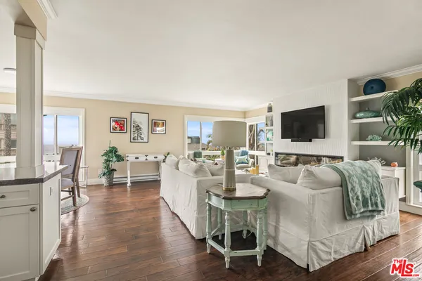a living room with fireplace furniture and a flat screen tv