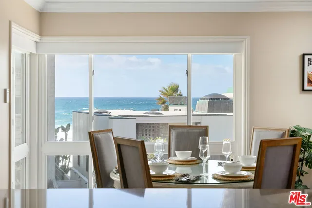 a dining room with furniture a window and kitchen view