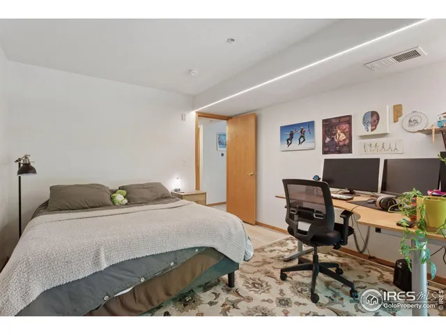 a bedroom with a bed and a desk