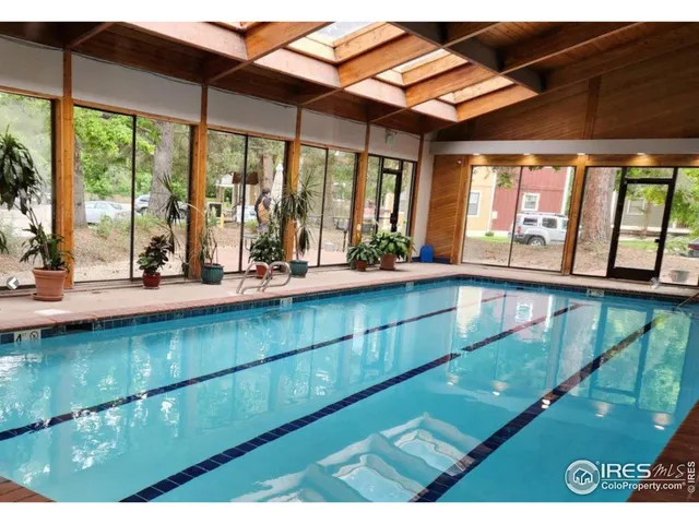 a view of a living room and kitchen with a large window