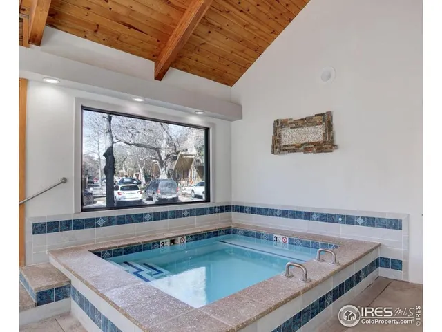 a view of a living room and a black umbrella next to a window