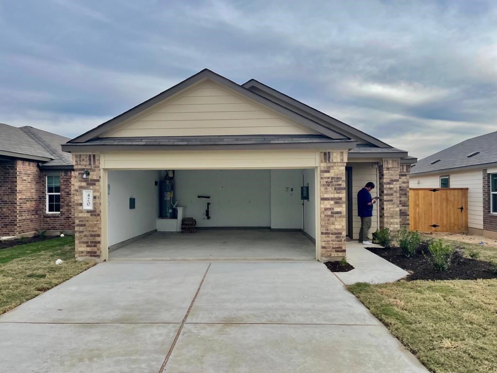 420 Perfect World Loop Jarrell, TX 76537 - Photo 17 of 17 a front view of house with yard outdoor seating and garage
