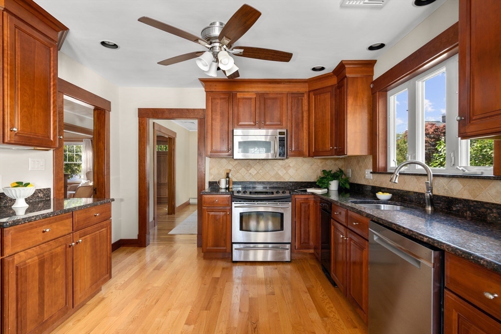 15 Laird Road Medford, MA 02155 - Photo 12 of 42 a kitchen with stainless steel appliances granite countertop a stove cabinets and wooden floor