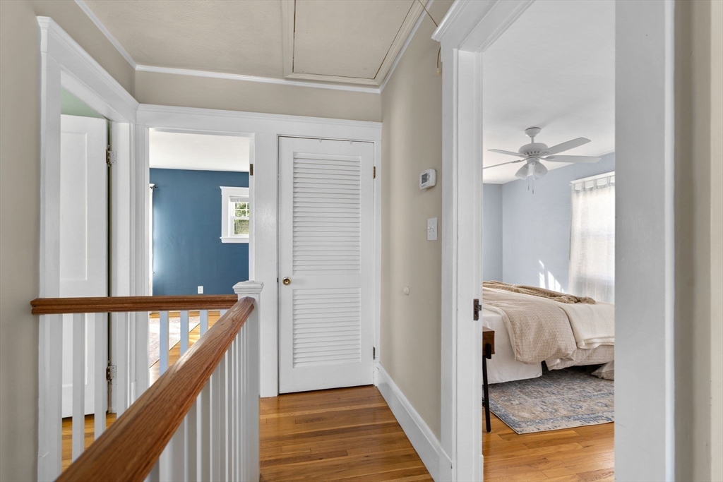 15 Laird Road Medford, MA 02155 - Photo 14 of 42 a view of a hallway with wooden floor and staircase