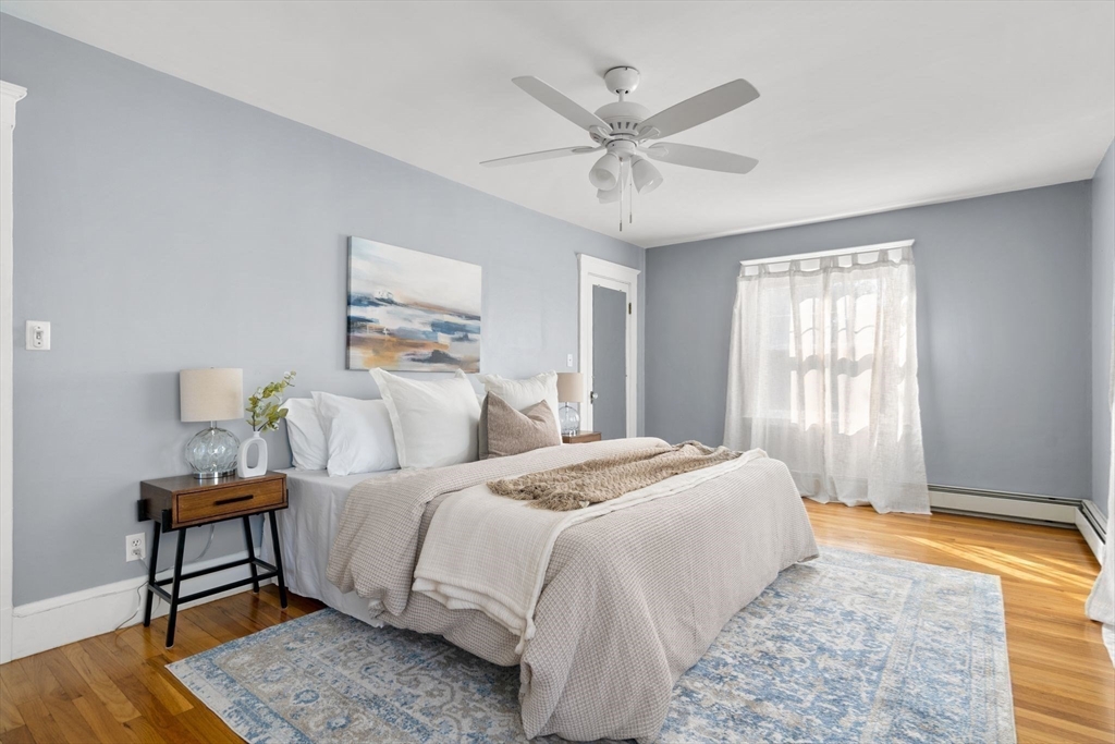 15 Laird Road Medford, MA 02155 - Photo 15 of 42 a bedroom with a bed and a chandelier