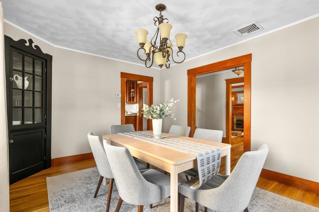 15 Laird Road Medford, MA 02155 - Photo 6 of 42 a view of a dining room with furniture wooden floor and chandelier