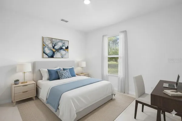 a bedroom with a bed and a desk