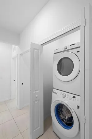 a view of a hallway with washer and dryer