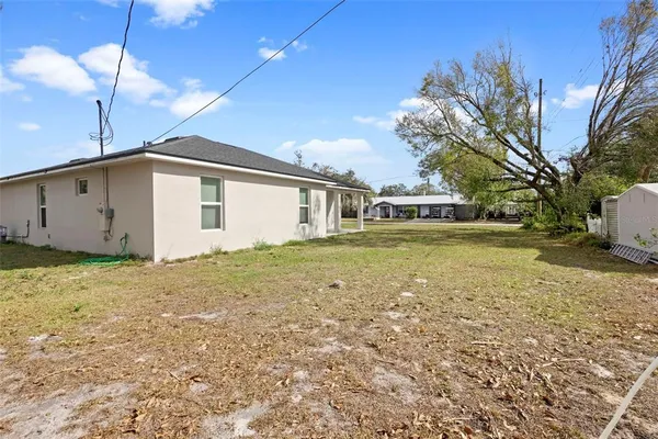 a view of a house with a backyard