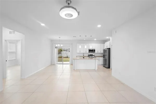 a view of kitchen with refrigerator and window