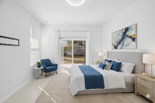 a bedroom with a bed and a large window