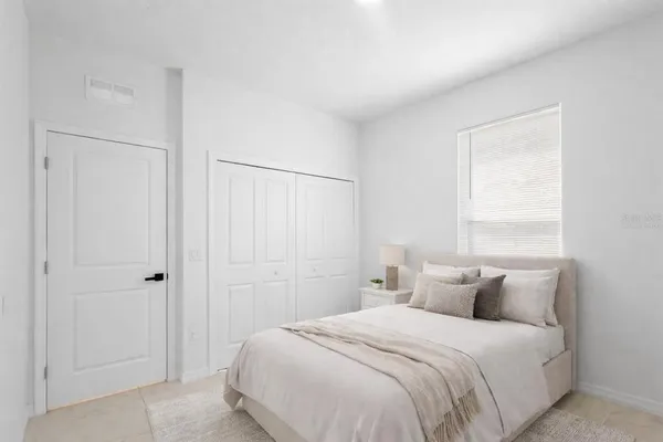 a bedroom with a bed and a window