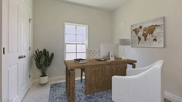 a view of a workspace with furniture and a potted plant