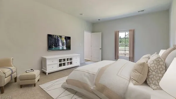 a bedroom with a bed and a couch