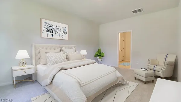 a bedroom with a bed and a lamp