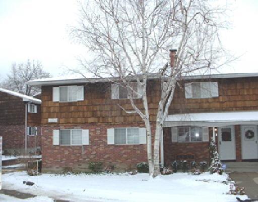 a front view of a house with yard and trees